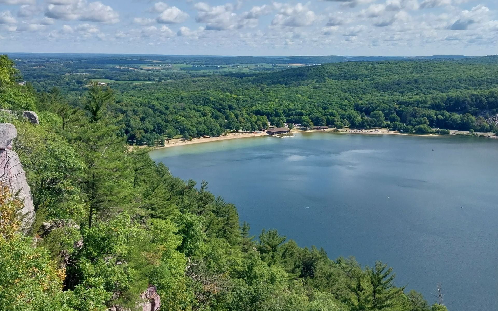 Quartzite bluffs rising 500 feet above the spring-fed lake at Devil's Lake State Park near Baraboo, Wisconsin