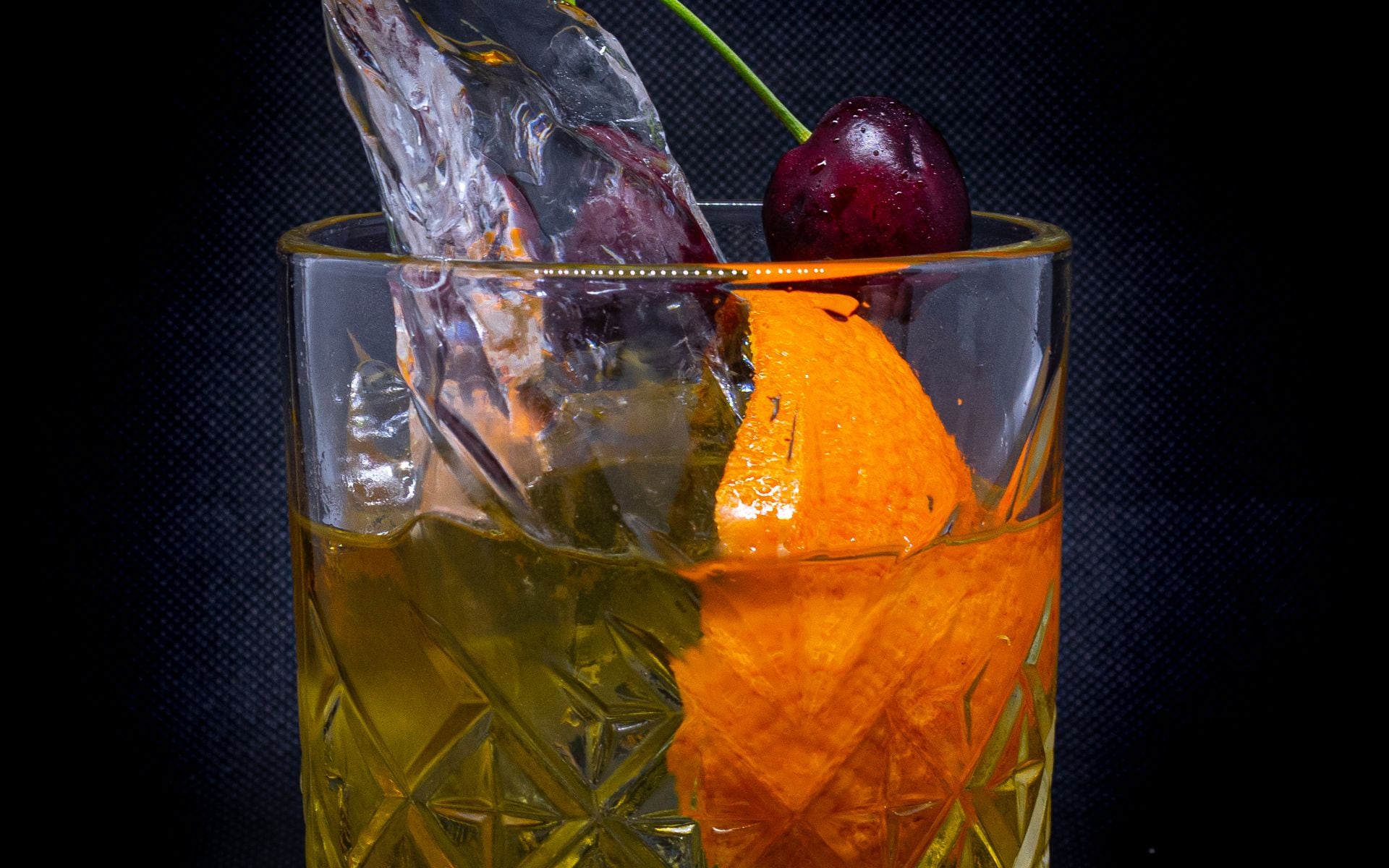 A brandy old fashioned cocktail with orange garnish and cherry on a supper club bar in Wisconsin
